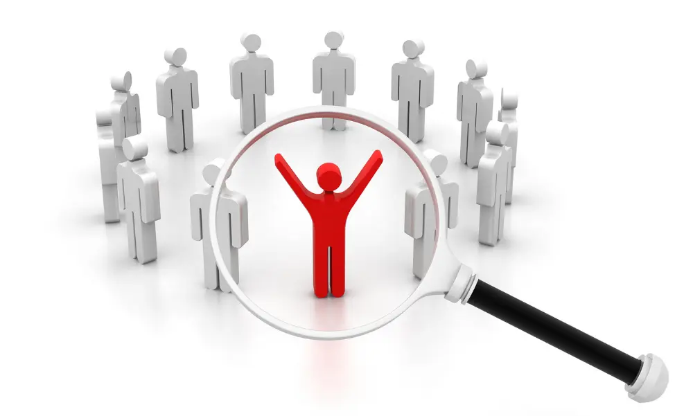 circle of people icons with a magnifying glass on one of them